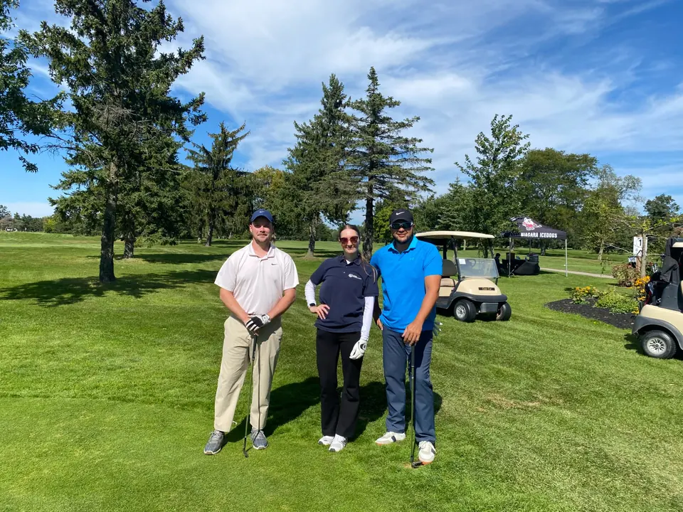 Green Integrations team members Anastasiia, Scott and Ernesto standing together on the fairway at Riverview Golf Club during the 2026 Rose City Kids Golf Tournament.