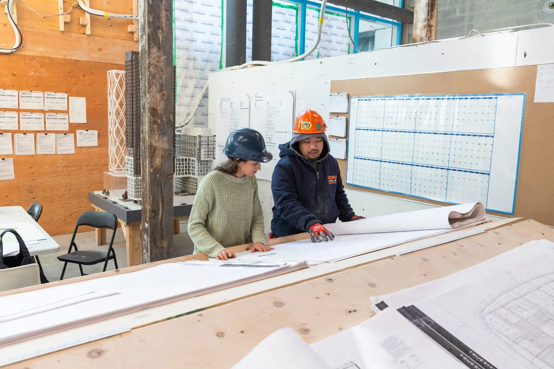 Architects and engineers reviewing commercial energy infrastructure plans for a building project