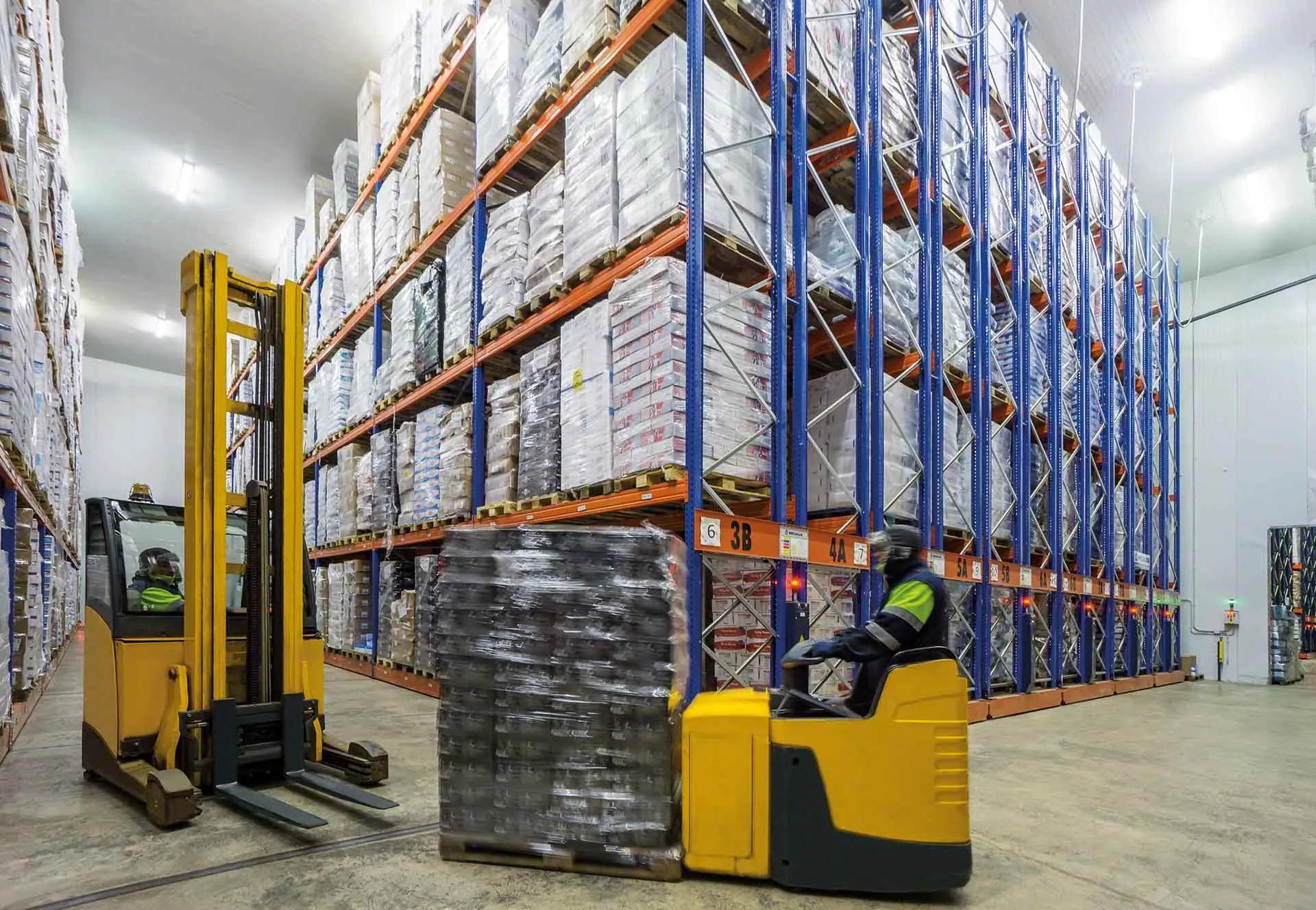 Cold storage warehouse facility with refrigeration systems and energy-intensive logistics operations