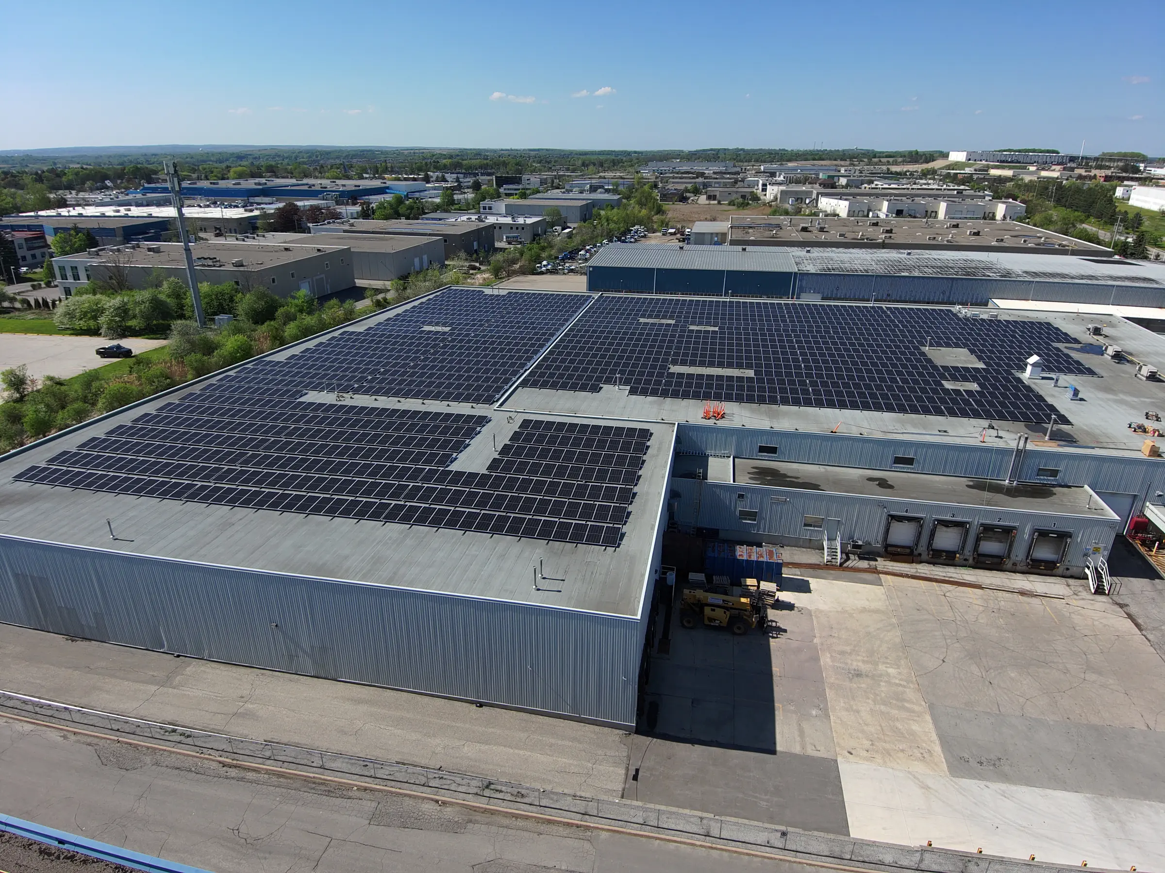 Aerial view of the Ce De Candy manufacturing facility rooftop, covered with commercial solar panels